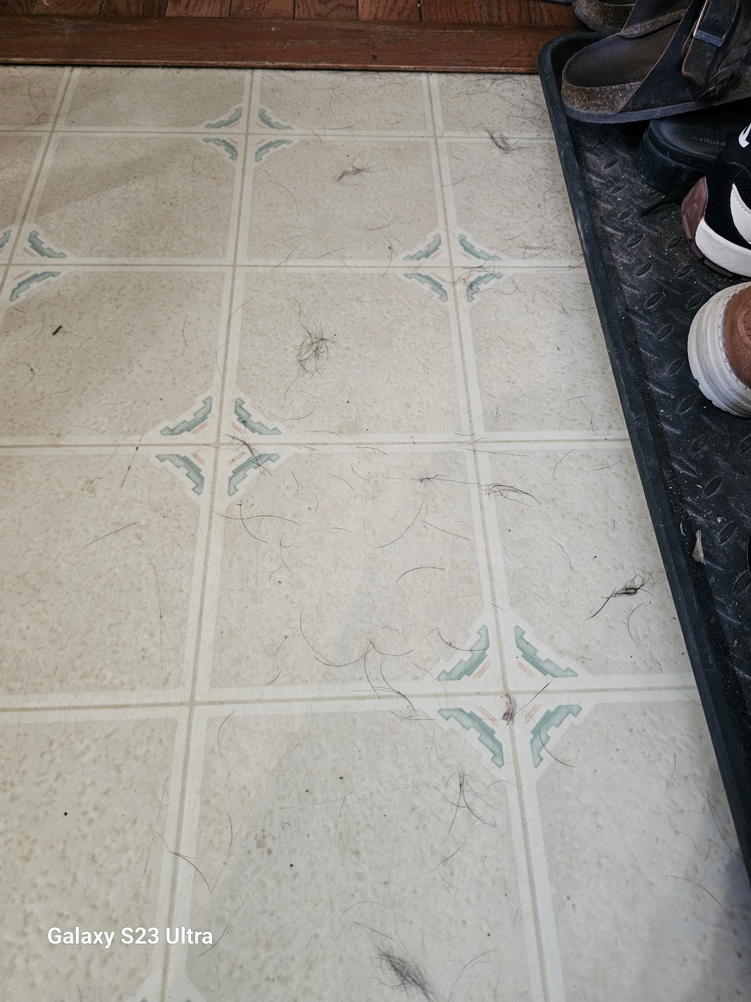 Cluttered residential entry floor before junk removal and cleaning