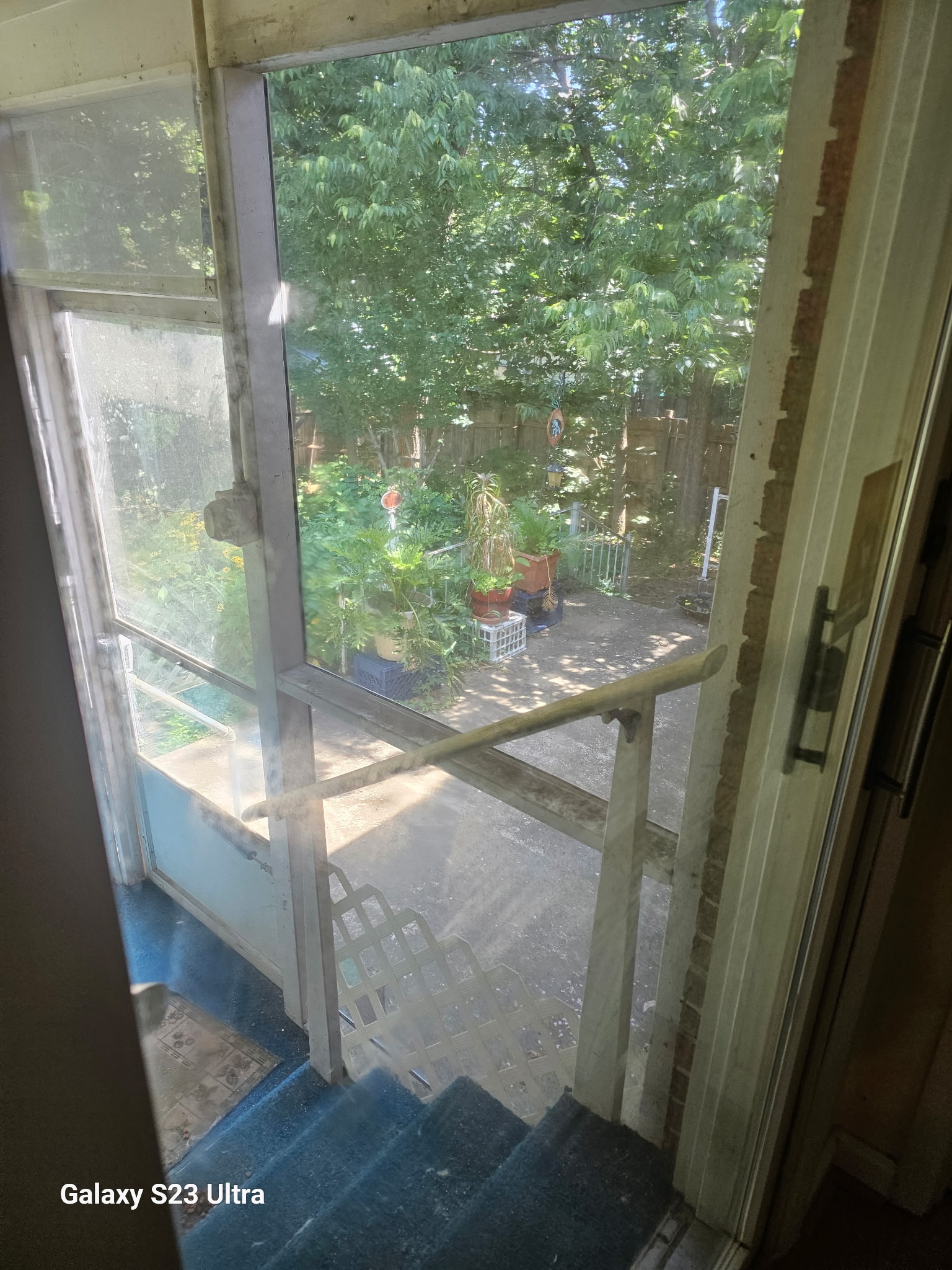 Residential glass door and screened porch looking out to the backyard