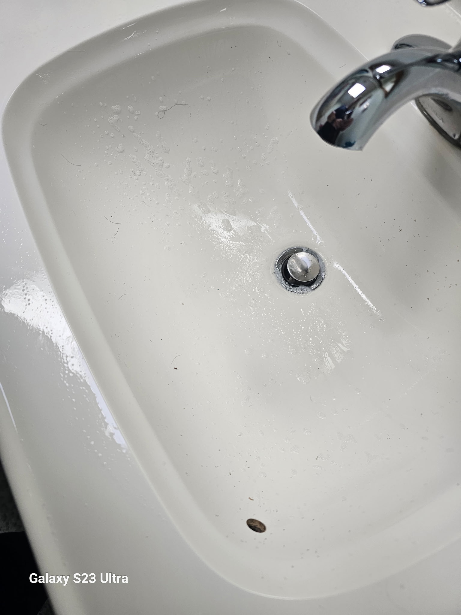 Bathroom sink basin before cleaning