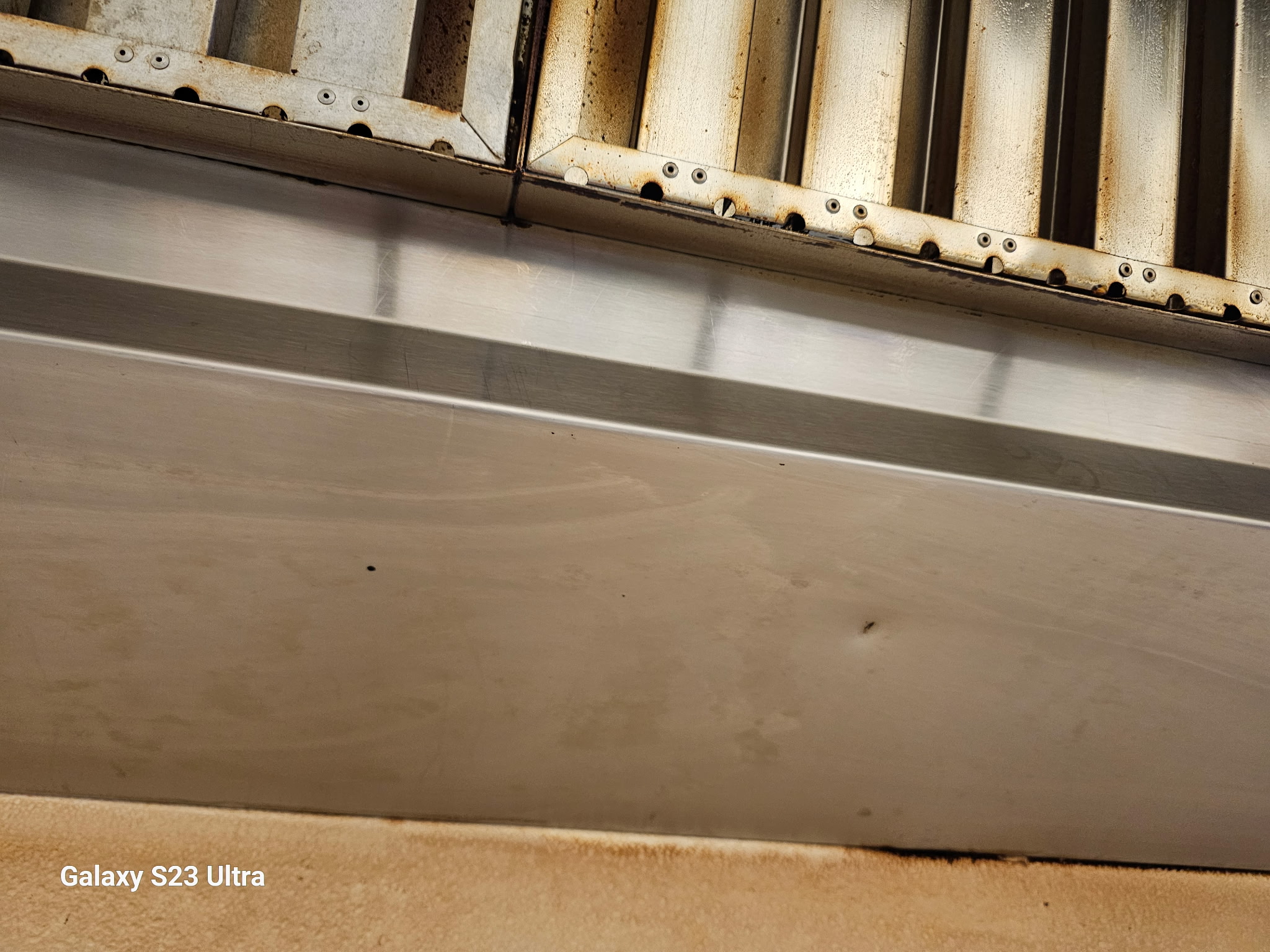 Stainless steel commercial kitchen hood after cleaning